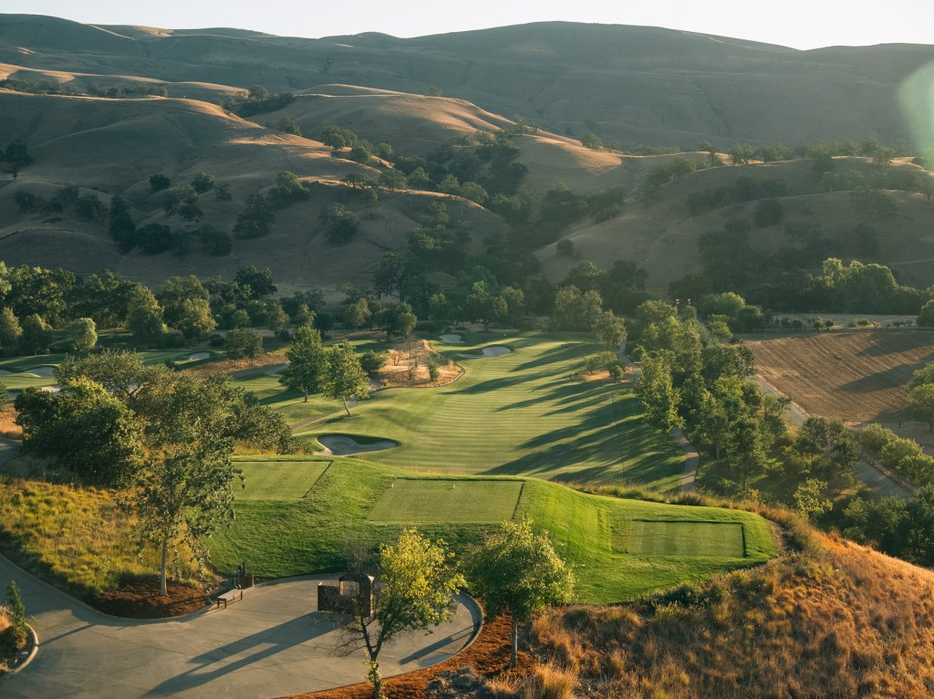 View of mountains by golf course 