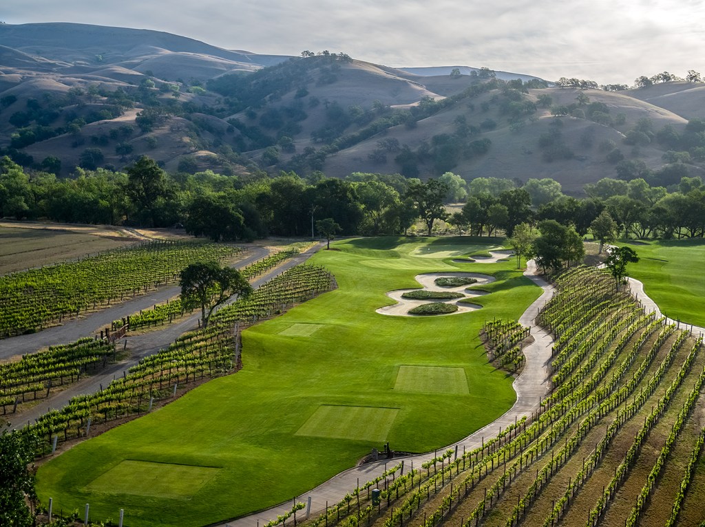 View of golf course with manicured greens