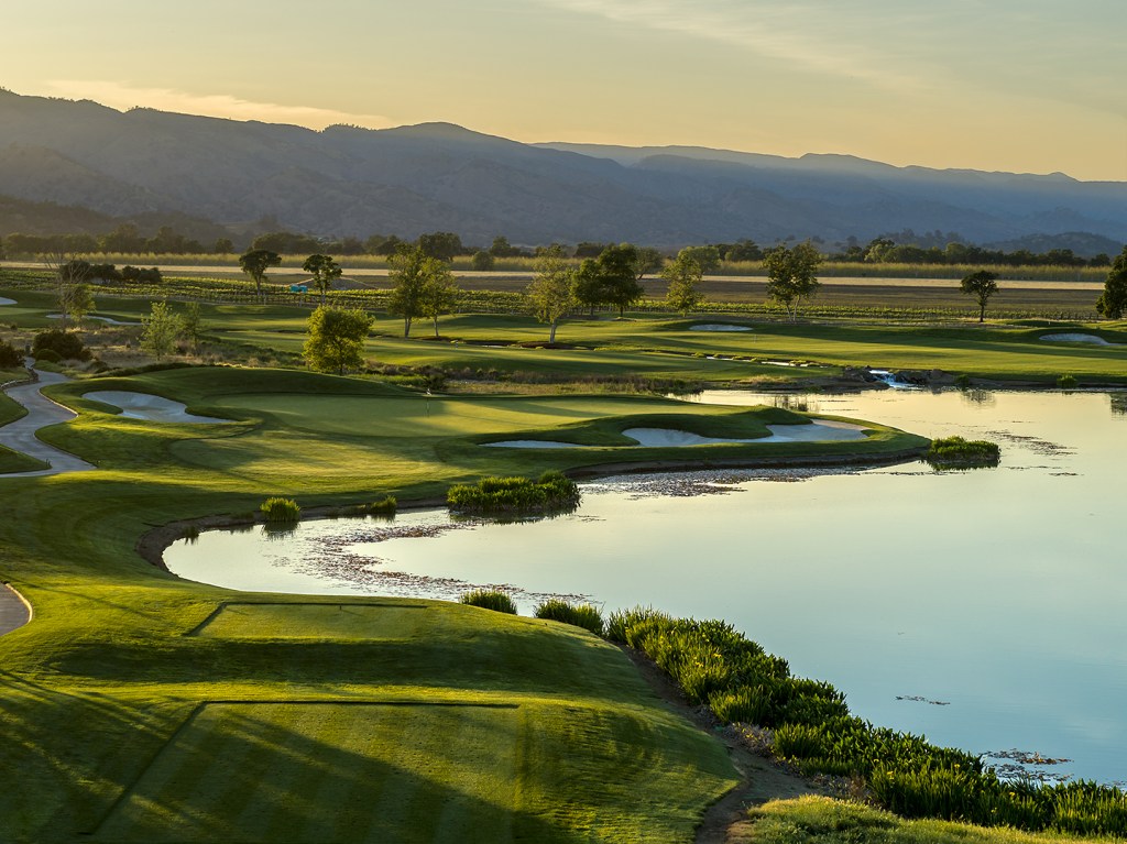 Golf course with water and mountains 